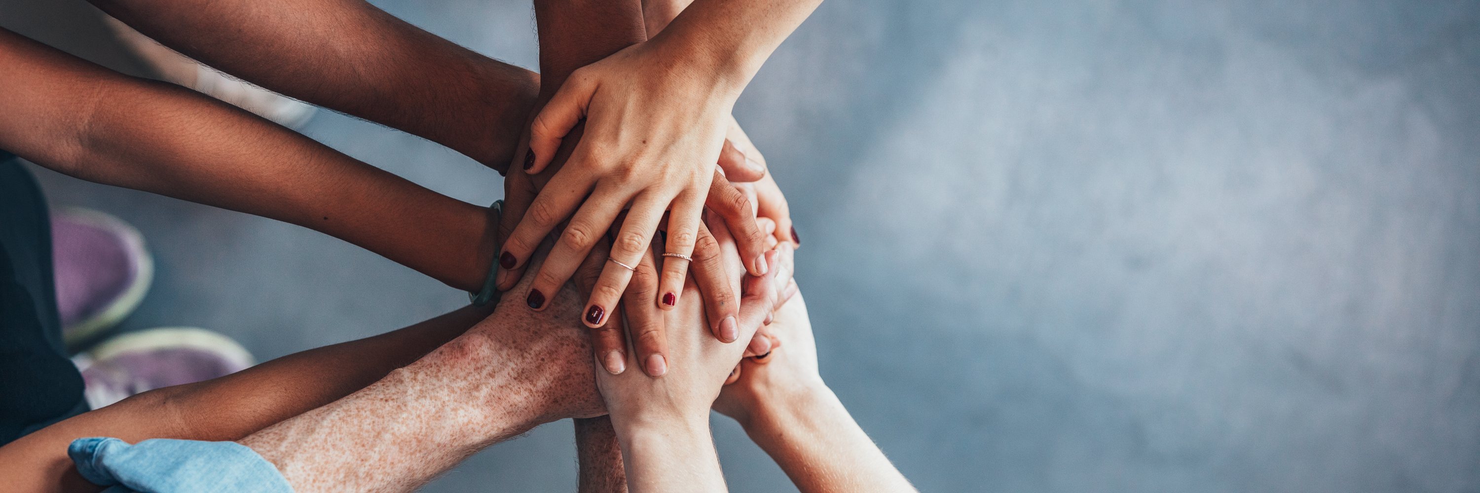 Stack of hands showing unity